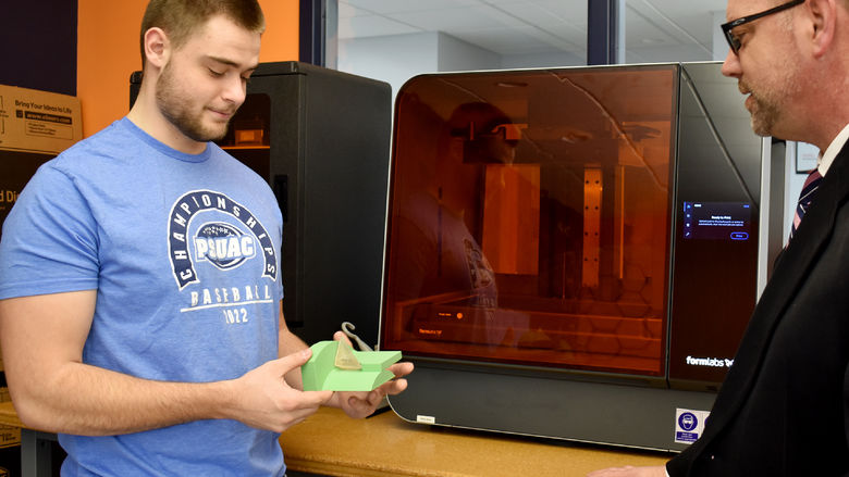 Dylan Treaster discussing a 3D printed part with North Central PA LaunchBox director Brad Lashinsky