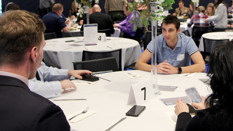 Carter Lindemuth, a junior at Penn State DuBois, has a conversation with professionals and employers at the table during the networking luncheon at the PAW Center