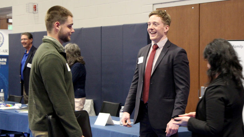 Penn State DuBois senior Dylan Treaster, left, talks with Zane Morgan, right, of CNB Bank and Penn State DuBois alumnus, during the career fair at the PAW Center