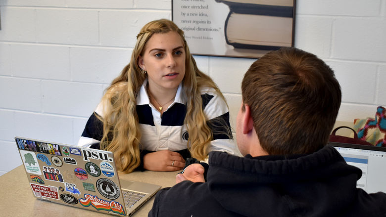 Larissa James-LaBranche helping a student as a tutor at the center for undergraduate excellence, also known as “The CUE”, at Penn State DuBois
