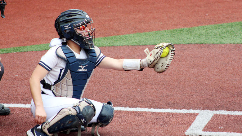 Larissa James-LaBranche catches and frames a pitch during a softball home game at Heindl Field in DuBois