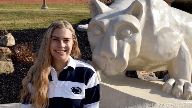 Larissa James-LaBranche with the Lion Shrine on the campus of Penn State DuBois