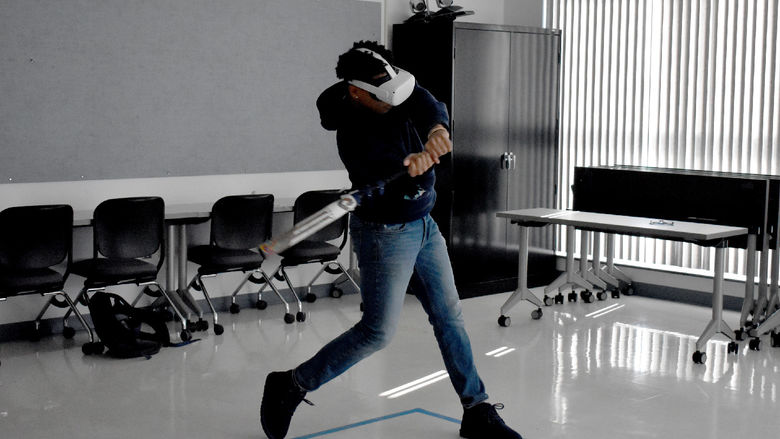 Penn State DuBois baseball player Jorge Rodriguez takes a swing during a batting practice session using virtual reality technology through the NCPA LaunchBox, powered by Penn State DuBois.