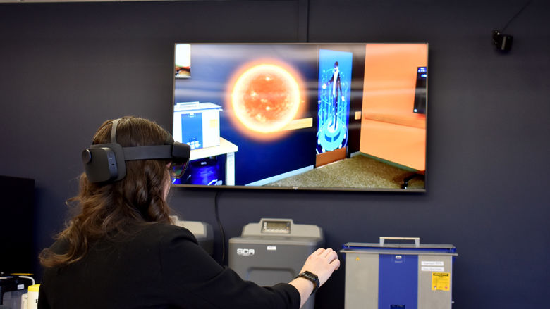 Penn State DuBois alumna Anna Raffeinner uses the augmented reality capabilities in the Idea Lab to explore the solar system.