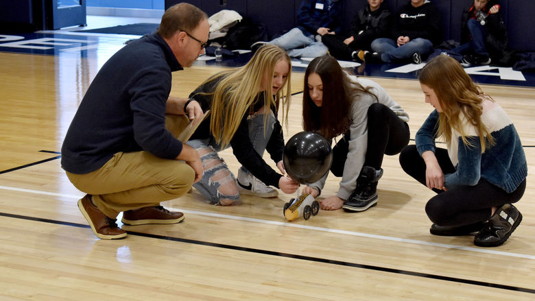 Students prepare to start their vehicle in the distance race at the PAW Center during STEAM Day at Penn State DuBois, under the guidance of Brad Lashinsky, program director for the North Central PA LaunchBox powered by Penn State DuBois.