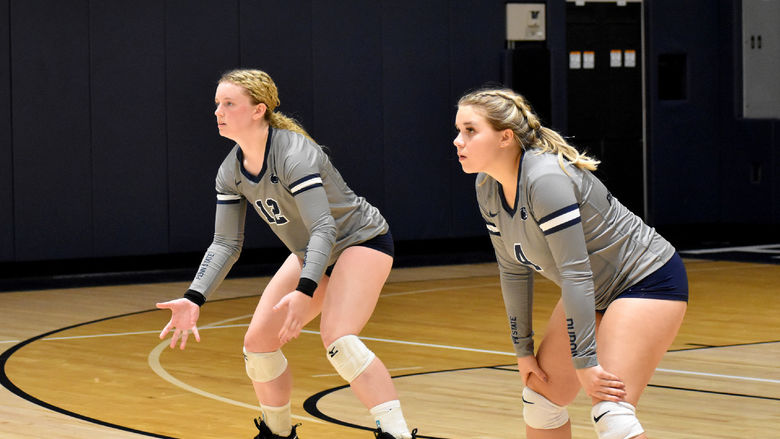 Penn State DuBois freshman Kamryn MacTavish, left, and junior Makena Baney, right, prepare to return the serve from Penn State New Kensington during the home match at the PAW Center.