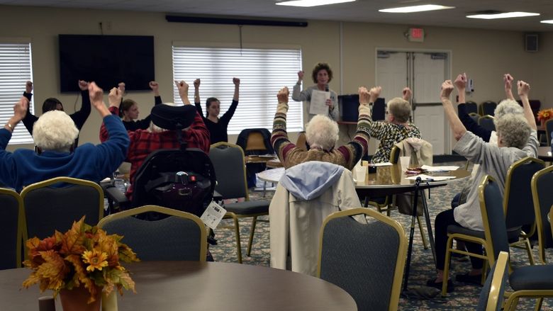LuAnn Delbrugge guides residents through upper body strengthening exercises to reduce fall risk.