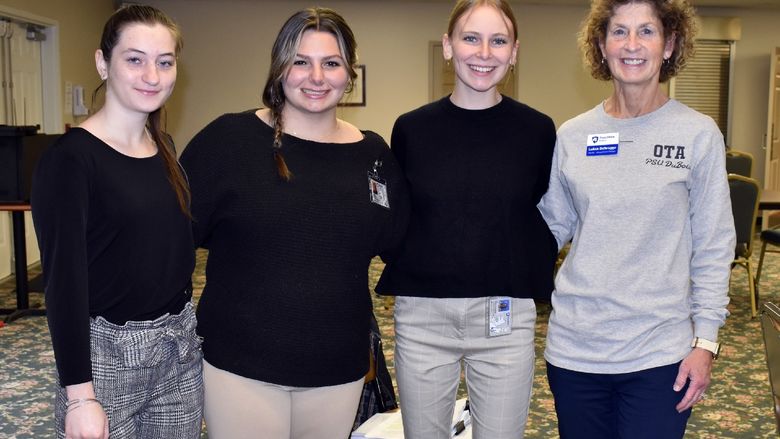 Occupational Therapy Assistant (OTA) students Maddie Barsh, Emily Busija, and Fiona Riss present with LuAnn Delbrugge, program coordinator and associate teaching professor for OTA.