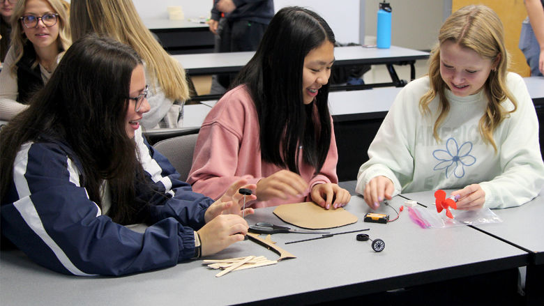 students working on a project at a table