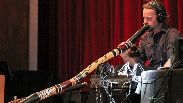 Didge Evolution’s Rob Thomas plays a didgeridoo.