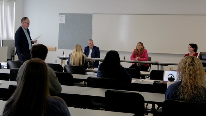 Members of the entrepreneur panel at Penn State DuBois receive an introduction from Brad Lashinsky, far left. Panel members seated at the table in front, from left to right, Michael Clement, Paula Foradora and Jennifer Reynolds-Hamilton.