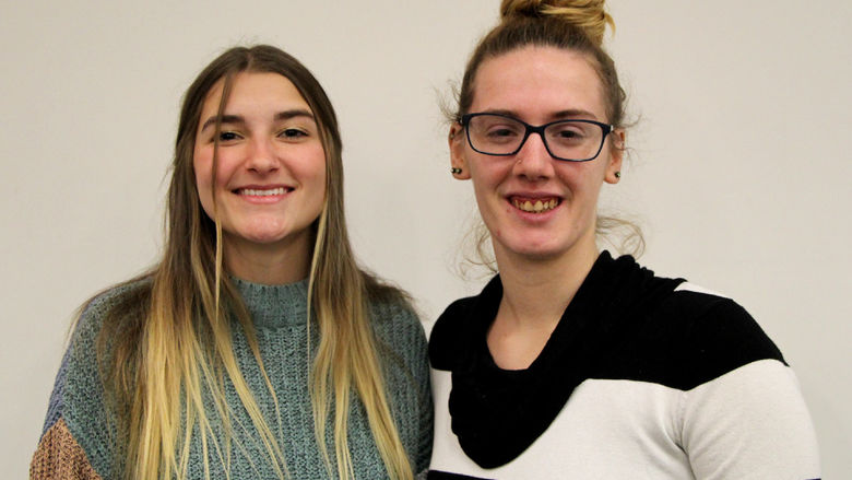 Penn State DuBois students Lilia Lion, left, and Cierra Hoffman, right, at the conclusion of their victimology presentations in Hiller Auditorium.
