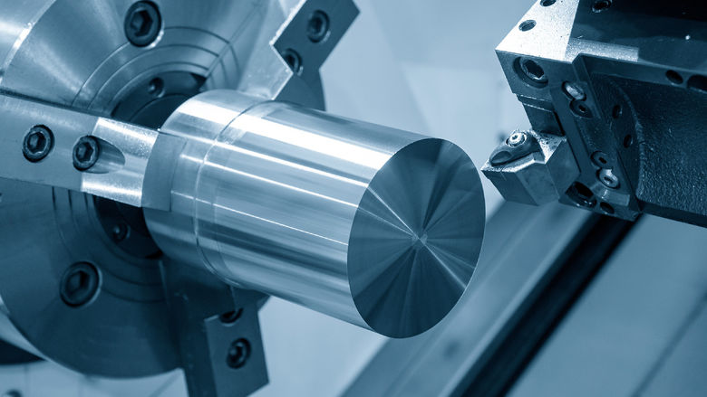 A CNC lathe machine preparing to cut a metal part.