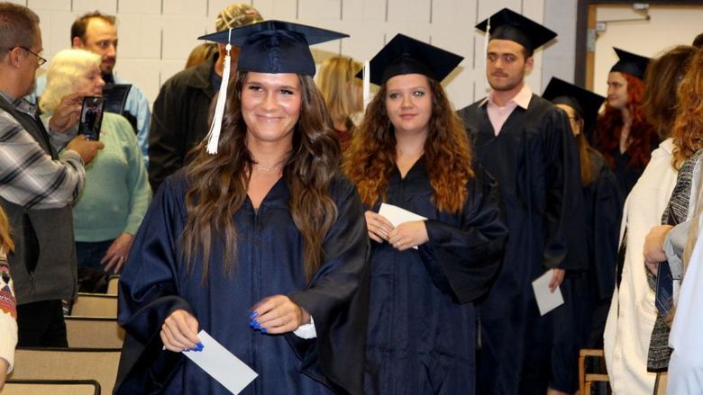 Graduates enter Hiller Auditorium during the processional at the beginning of the commencement celebration at Penn State DuBois.