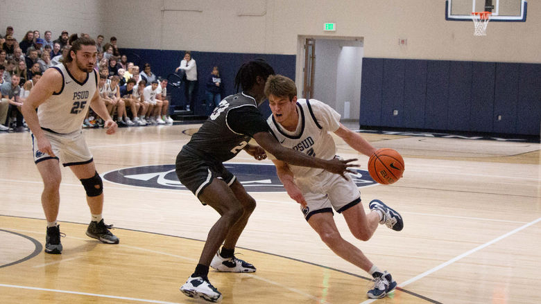 Penn State DuBois junior forward Will Helton drives past the reach of his defender during the contest with Penn State New Kensington at the PAW Center