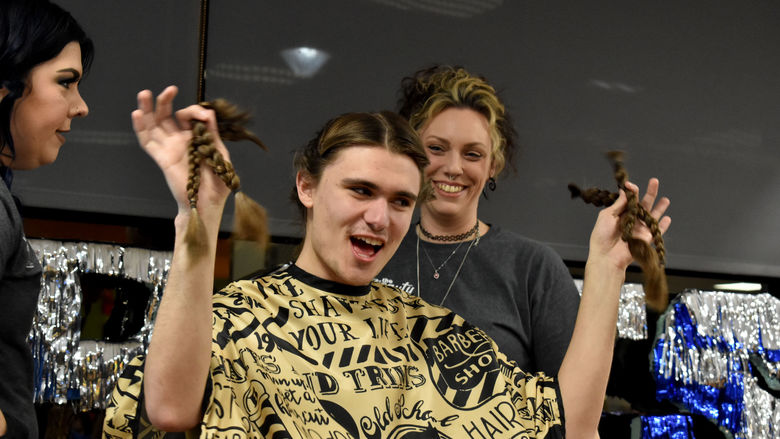 Penn State DuBois student and THON dancer Gaven Wolfgang proudly displays his freshly cut hair at the hair auction