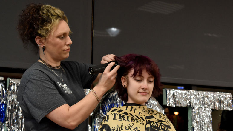 Marilla Mancuso has her hair buzzed during the THON hair auction at Penn State DuBois