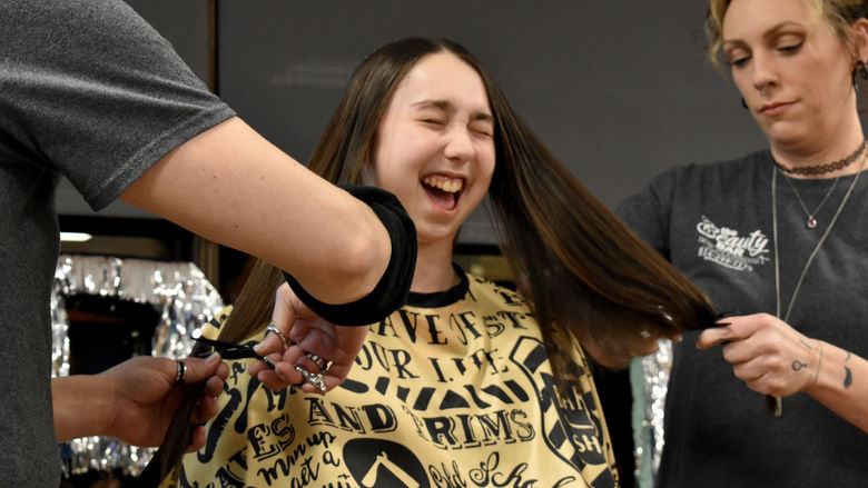 Elise Dufour shows her excitement as her hair is cut during the THON hair auction