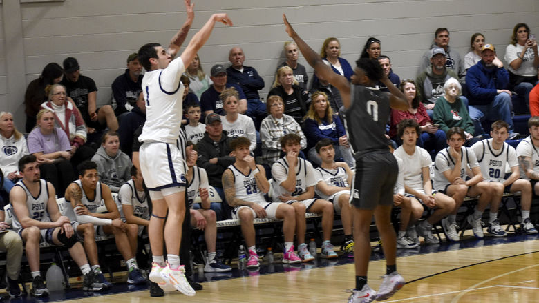 Penn State DuBois sophomore guard Christopher Frontera attempts a three-point shot over a Greater Allegheny defender during the game at the PAW Center