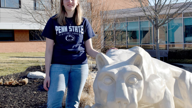 Taylor Charles next to the Nittany Lion shrine on the campus of Penn State DuBois