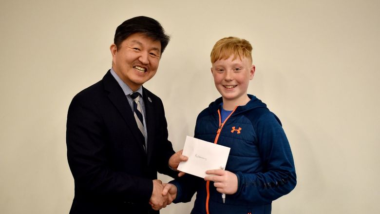Kai Caskey of Saint Marys, right, receives the individual award for the preliminary round from Jungwoo Ryoo, chancellor and chief academic officer of Penn State DuBois