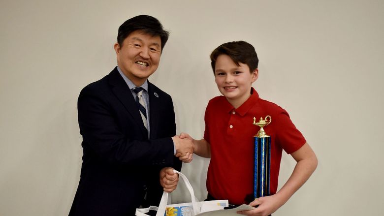 Xavier O’Link of Clearfield, right, receives the individual award for the final rounds from Jungwoo Ryoo, chancellor and chief academic officer of Penn State DuBois