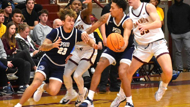 Penn State DuBois junior forward Ashton Fortson hands the ball off to junior guard Jordin Sommers during a basketball game earlier in the season.