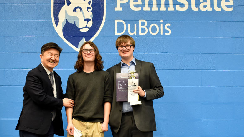 Individual award winners Henry May, middle, and Connor Siple, right, are recognized by Jungwoo Ryoo, chancellor and chief academic officer at Penn State DuBois, for their accomplishments during the Senior Scholastic Challenge, held at Penn State DuBois.