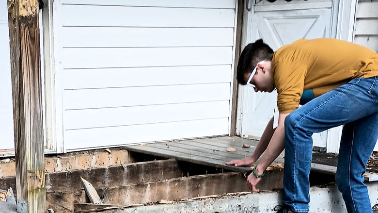 -	Penn State DuBois student Remington Crawford works hard on a home repair project during the spring break service trip to Kentucky through the Christian Student Fellowship organization at Penn State DuBois.