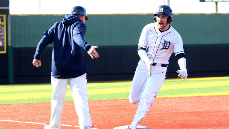 Penn State DuBois senior outfielder Brandon Sicheri celebrates his home run with assistant coach Garrett Brown as he rounds third base during a recent home game at Showers Field in DuBois.