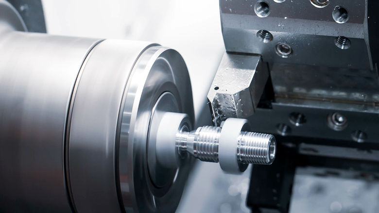 A CNC lathe machine completing a cutting process.