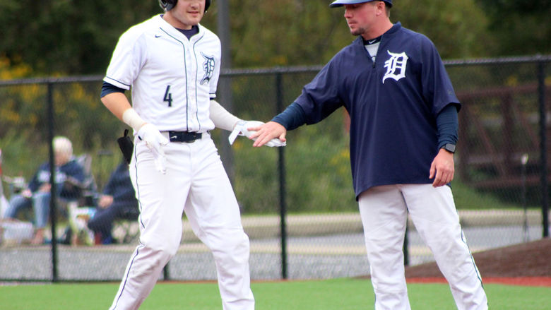 Penn State DuBois baseball coach Garrett Brown congratulates senior Brandon Sicheri after reaching base during a game in the 2023-24 season. Brown has now been named the new head coach of Penn State DuBois baseball.