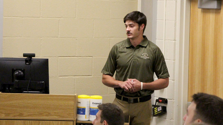 Penn State DuBois student Grant Grimaldi reviews his presentation slide while sharing his internship experience with those gathered in the Swift building, on the campus of Penn State DuBois.