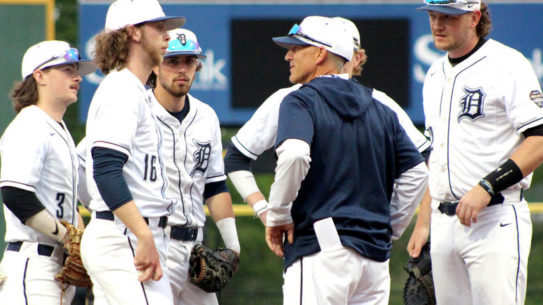 Former Penn State DuBois head coach Tom Calliari, center, talks with his players during a mound visit in a game during the USCAA Small College World Series.