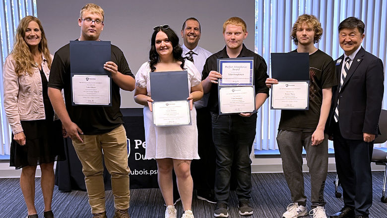 Students and staff members gather for a group photo during the graduation ceremony for the post high school CNC program at Penn State DuBois. From left to right, Pam Streich, executive director of  Workforce Solutions of North Central Pennsylvania, Luke Eckert, Skylar Bowers, John Brennan, director of continuing and community education at Penn State DuBois, Tyler Baughman, Hunter Tharp, Jungwoo Ryoo, chancellor and chief academic officer at Penn State DuBois.