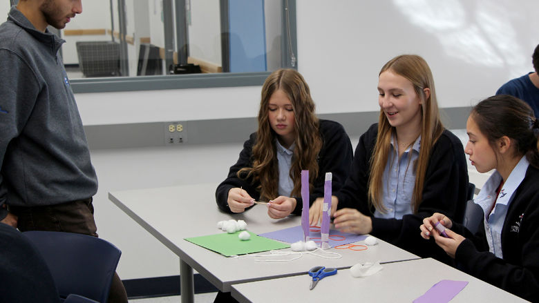 Students attending Discover Engineering Day at Penn State DuBois discuss their design ideas for a project with a member of the Engineering Ambassadors Program, who offered insights and suggestions on improvements.