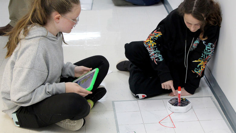 Students attending Discover Engineering Day at Penn State DuBois learn about programing by using a robot to draw different designs, such as shapes and letters.