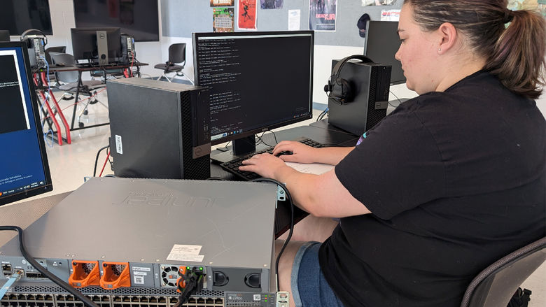 Penn State DuBois student Abagail Kellogg-Long works through the initial setup of a Juniper switch before installation of the device in the IST lab on campus.