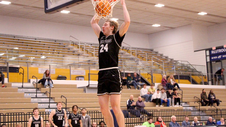 Penn State DuBois senior forward Beau Verdill slams the ball home during a drive in the lane in the second half of the team’s game at Clarion University on Nov. 26.