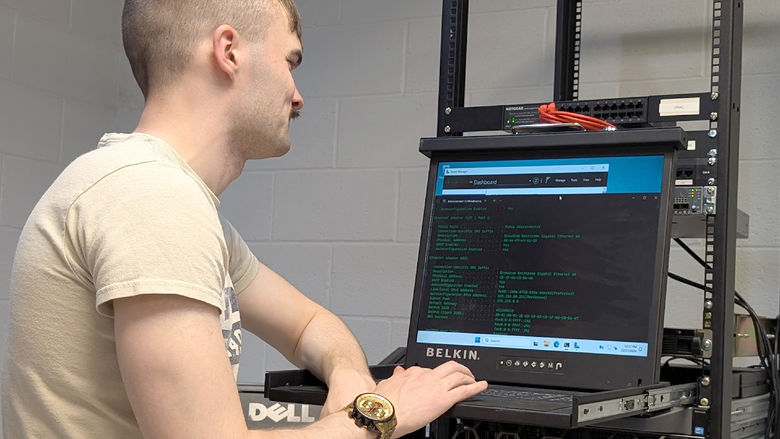 Penn State DuBois student Triston Kriner works through the set-up procedures for one of the enterprise-class virtualization servers that the campus received as part of a partnership with Penn State IT.