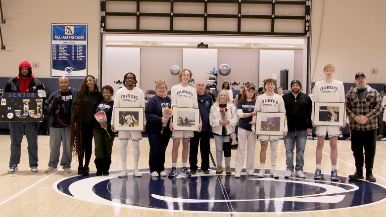 A group photo from the 2025 Penn State DuBois men’s basketball team senior day festivities. Members of the team that were honored are joined by family members on the PAW Center court.