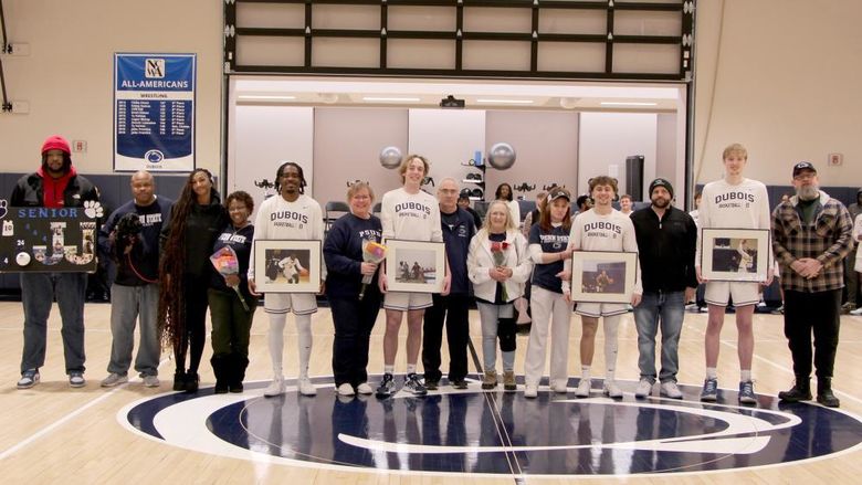 A group photo from the 2025 Penn State DuBois men’s basketball team senior day festivities. Members of the team that were honored are joined by family members on the PAW Center court.