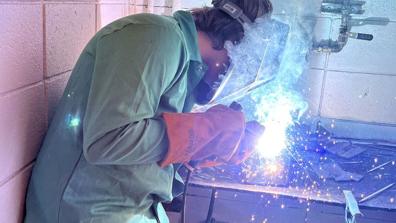 Dutch Manufacturing student Isaac Perlick works on his cube project using the shielded metal arc welding process.