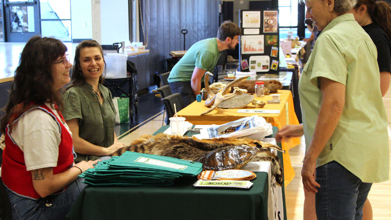 Representatives from the Clearfield County Conservation District speak with members of the public during the earth day celebration at Penn State DuBois.