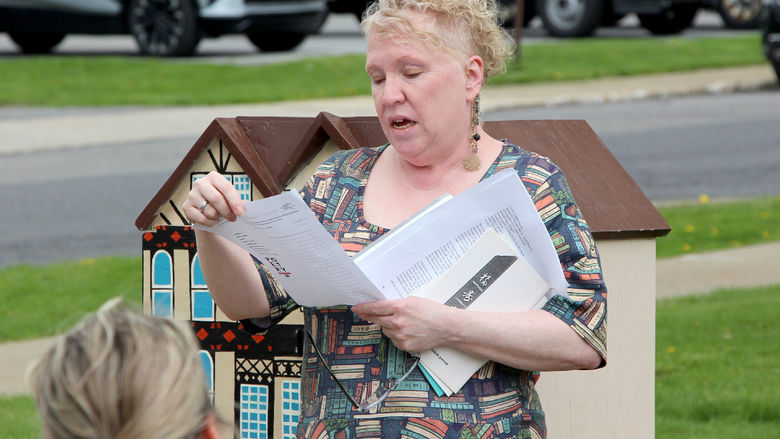 Jackie Atkins, assistant teaching professor of English, reads one of her husband Tony Vallone’s original poems during the Little Free Library dedication at Penn State DuBois on April 29.