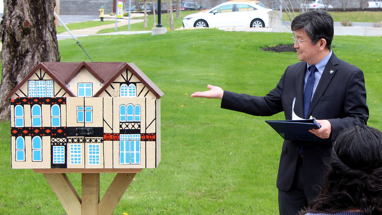 Jungwoo Ryoo, chancellor and chief academic officer at Penn State DuBois, draws attention to the newly installed Little Free Library during its dedication ceremony held on April 29.