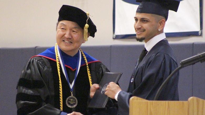 New Penn State graduate Ashwin Upadhyaya, who earned a bachelor’s degree of science in business, receives his diploma from Jungwoo Ryoo, chancellor and chief academic officer, during the spring commencement ceremony at Penn State DuBois.