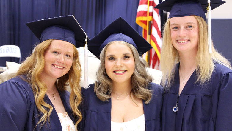 New Penn State graduates Chelsea Busatto, left, Makena Baney, center, and Kamryn Mactavish, right, smile for a photo after the spring commencement ceremony at Penn State DuBois. Busatto, Baney and Mactavish are teammates on the Penn State DuBois softball team.