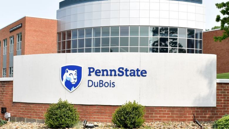 One of the entrance markers at Penn State DuBois. The entrance marker sits in the foreground, with the DEF Building visible in the background.
