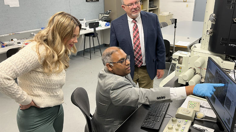 Ramakrishnan Rajagopalan, professor of engineering at Penn State DuBois, demonstrates how some equipment and processes work within one of the engineering labs at Penn State DuBois. Tony Zaffuto, founder and president, right, and Bethany Zaffuto, marketer, left, from Metaltech look on during the demonstration.